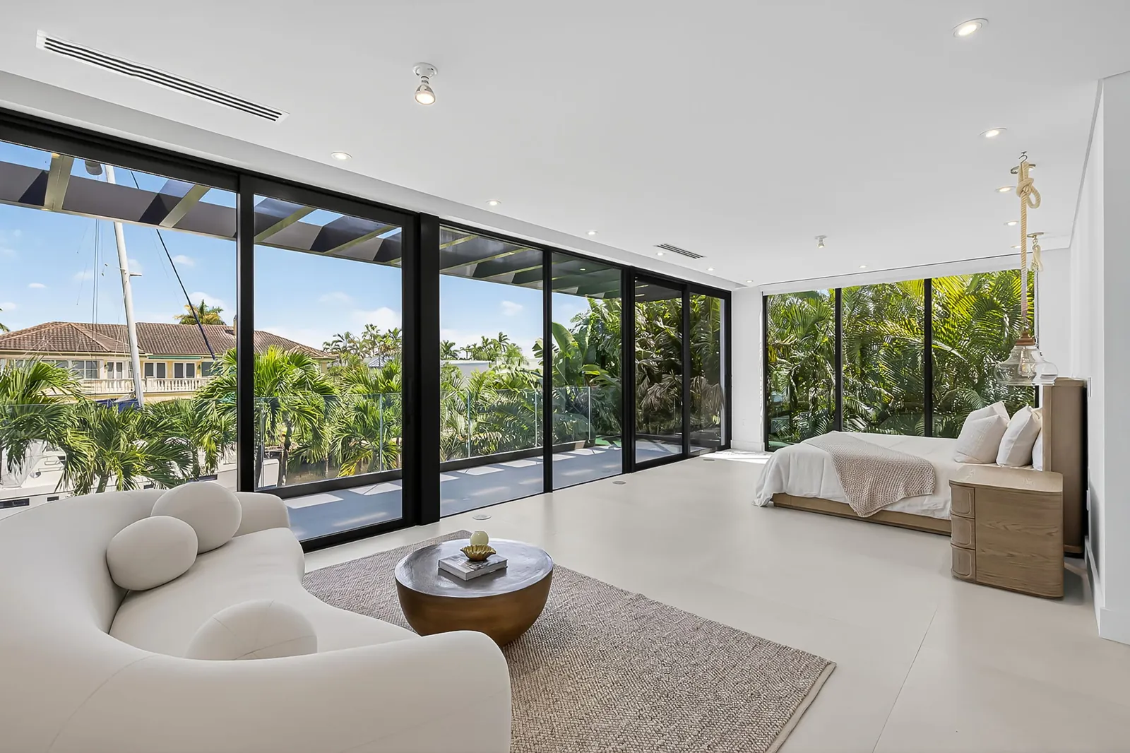 Primary suite with a sitting area and floor-to-ceiling windows overlooking the canal
