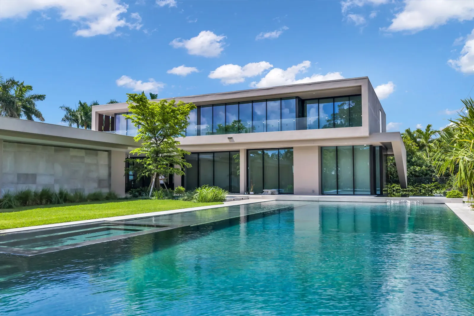 Glass-walled modern home with lap pool in Boca Raton