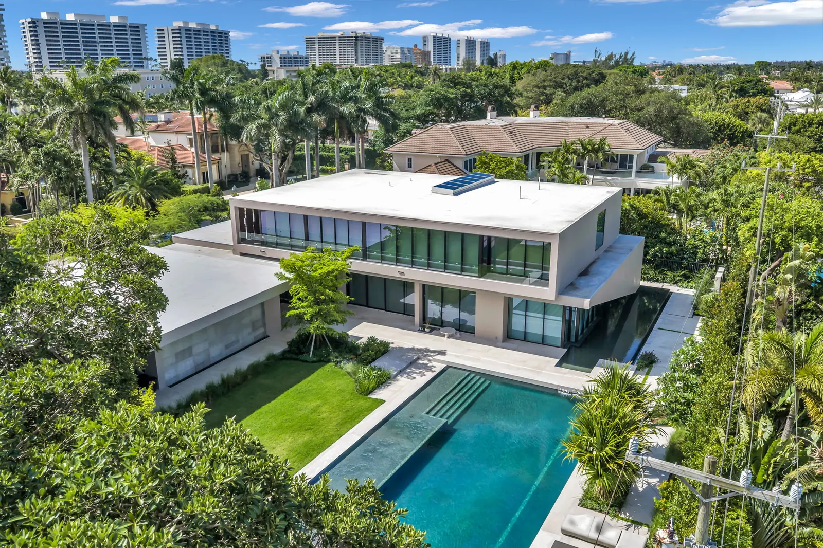 Drone aerial of a modern Boca Raton estate with a long pool