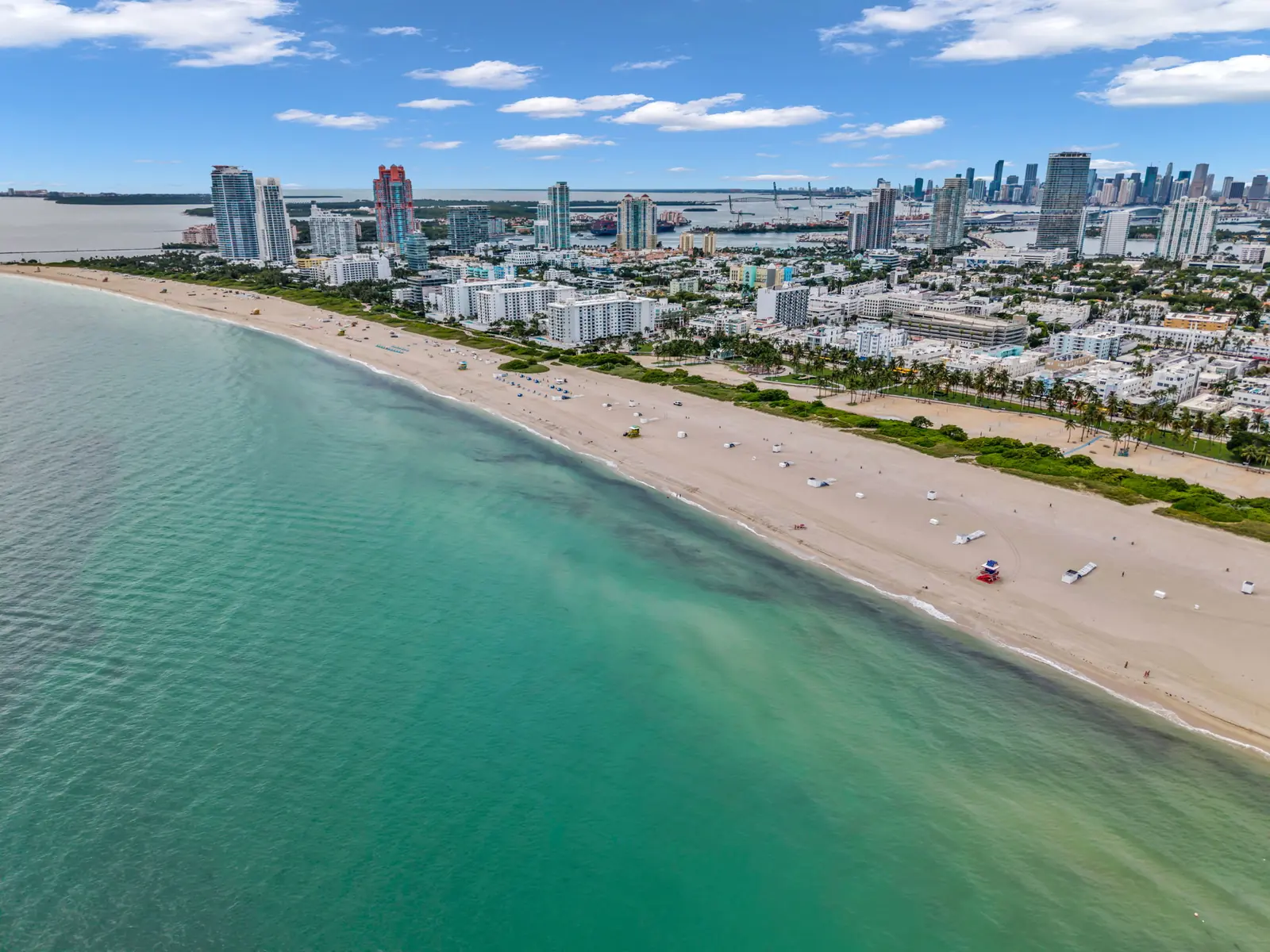 Drone aerial of the Miami Beach shoreline and turquoise water with the Miami skyline