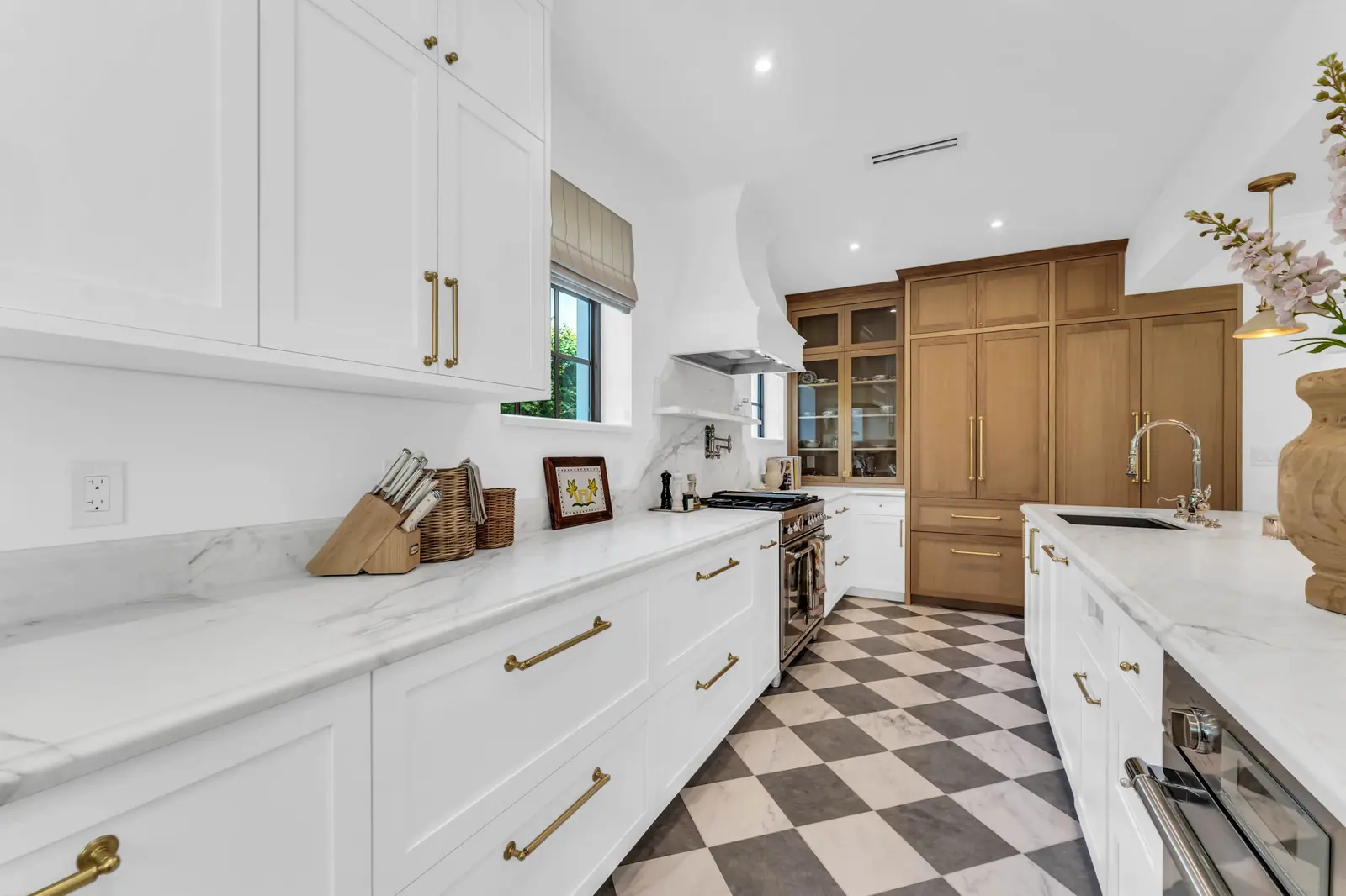 Kitchen with checkered floor and wood cabinetry in Miami
