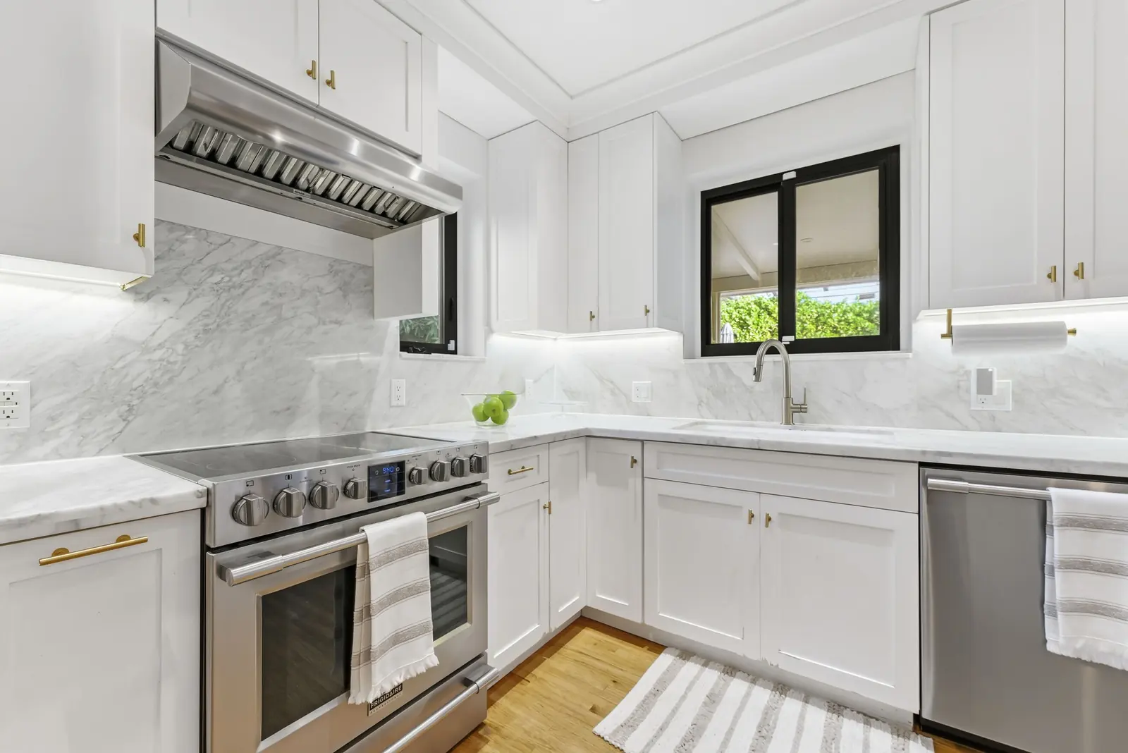 White kitchen with marble backsplash in Miami Shores