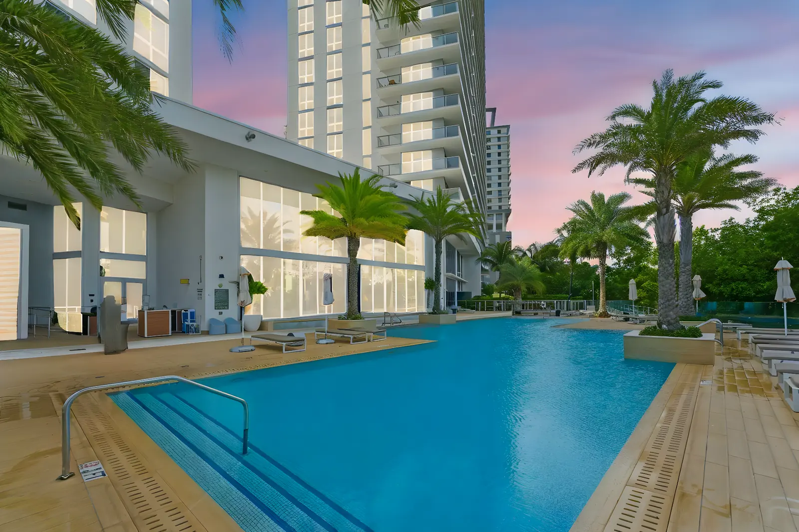 Resort-style condo pool at dusk in North Miami Beach