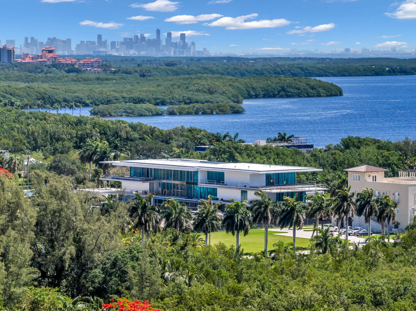 Aerial of a waterfront estate in Palmetto Bay with the Miami skyline across the bay