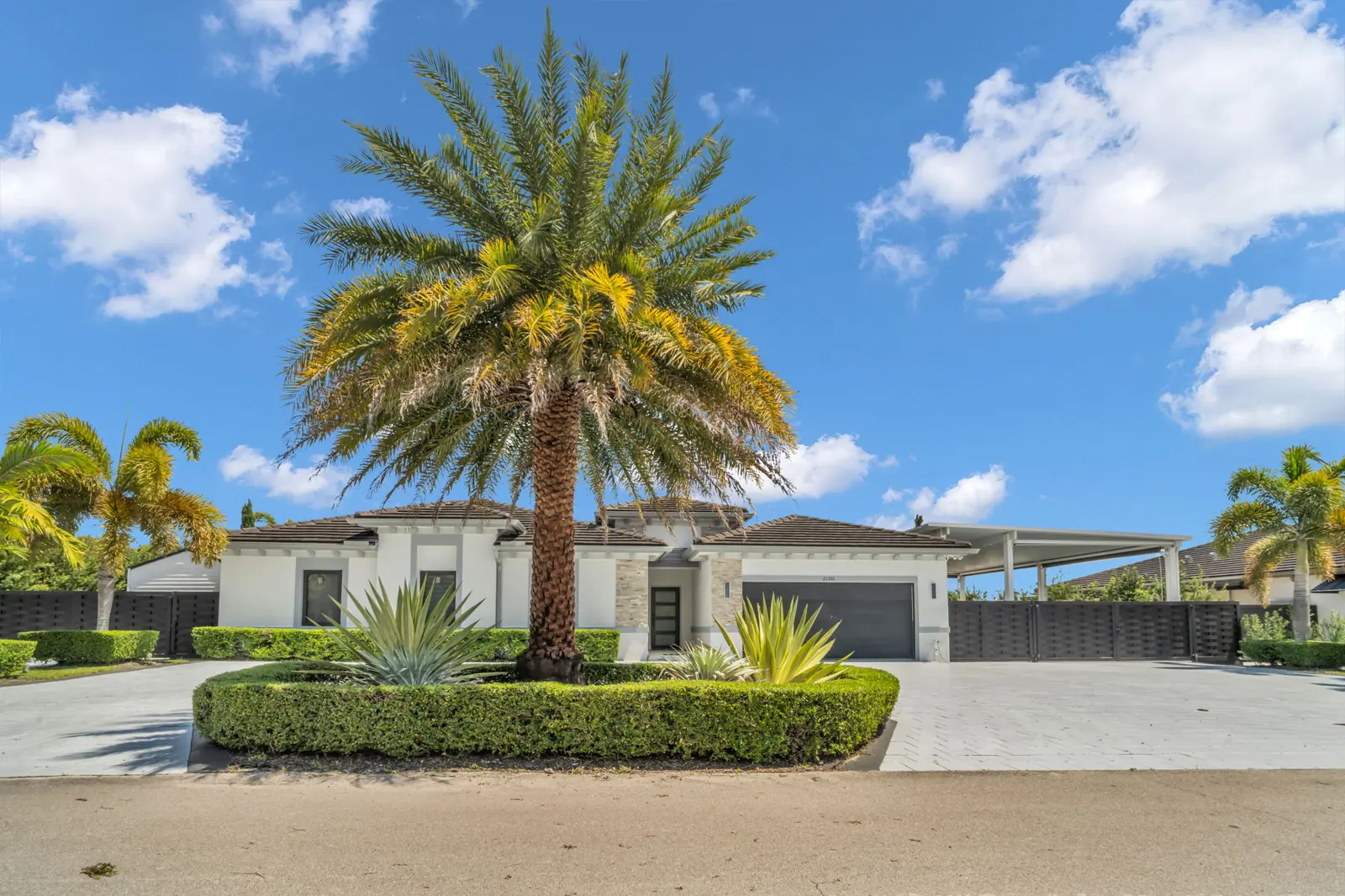 Modern home exterior with royal palm in Quail Heights