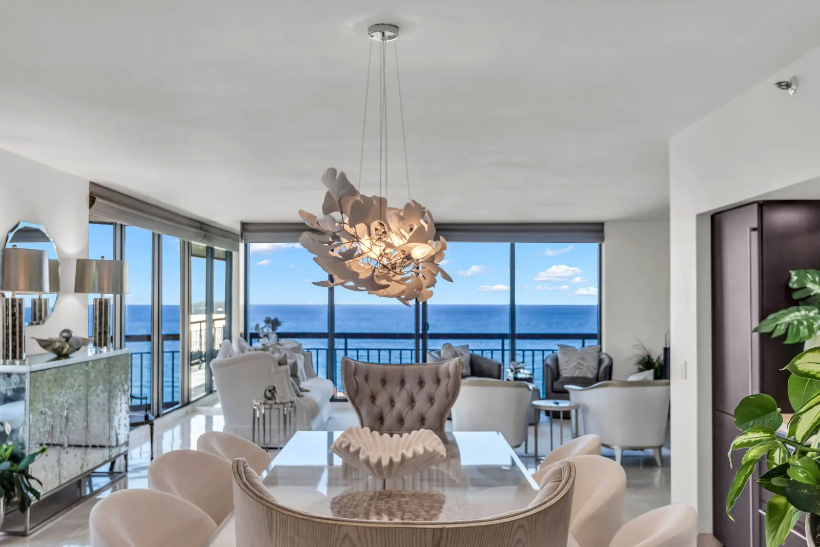 Dining room with sculptural chandelier and full ocean view in West Palm Beach