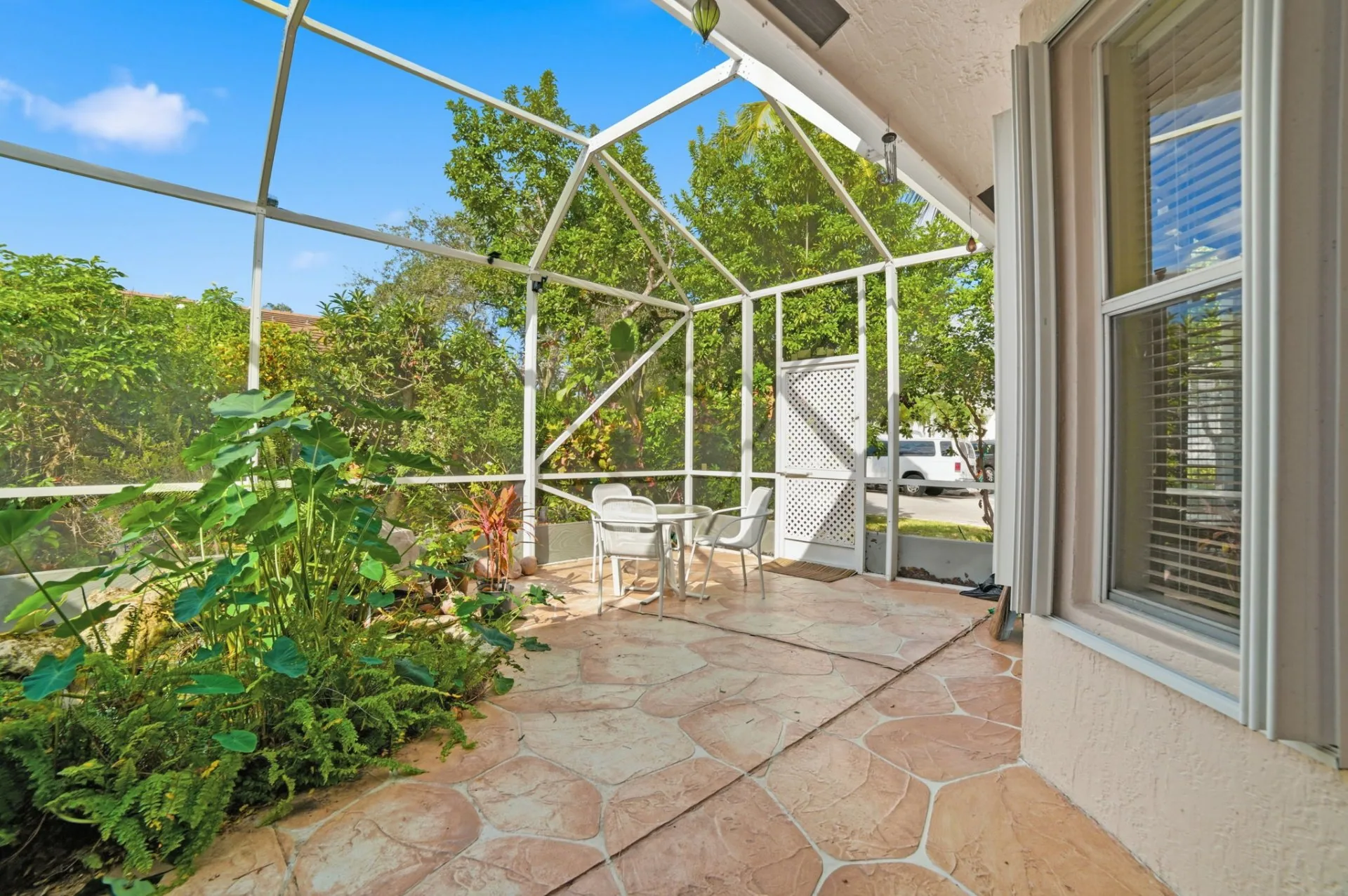 Screened Patio with Garden View - Featured Real Estate Photography by Estate Shutter